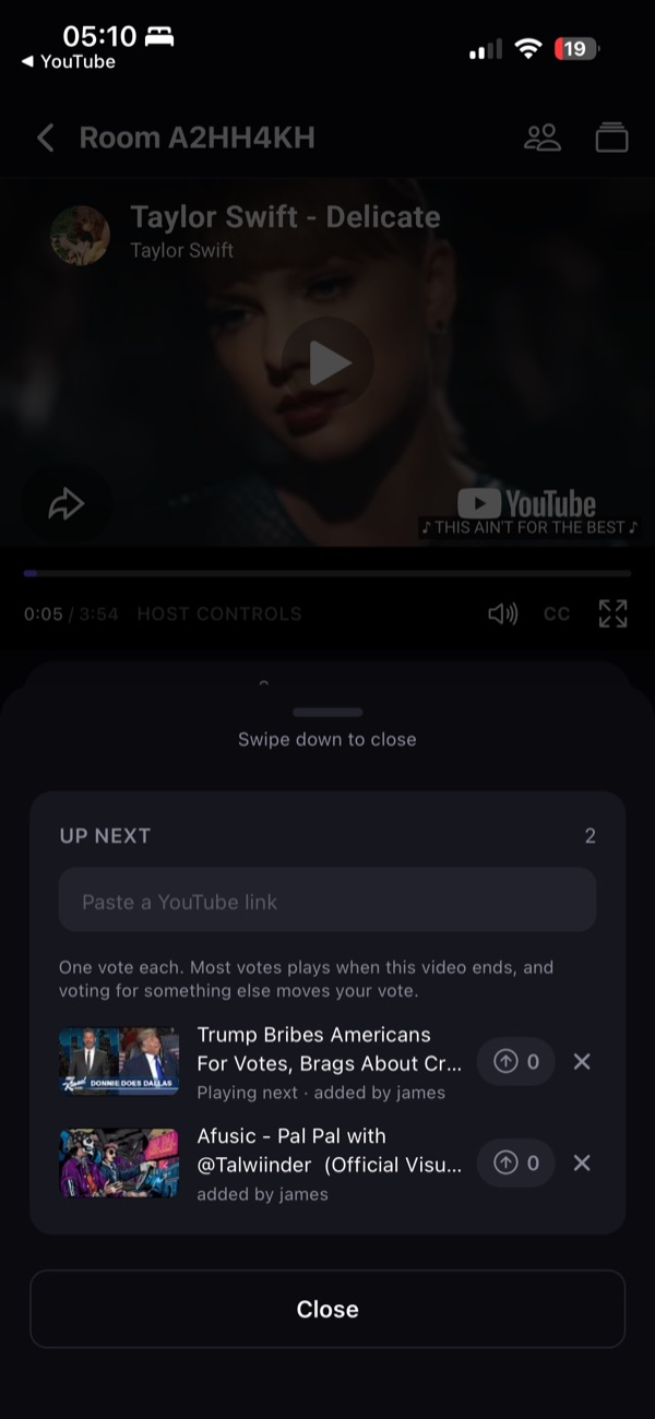 A Synckro room playing a music video, with the queue open below it and two videos waiting to be voted on.